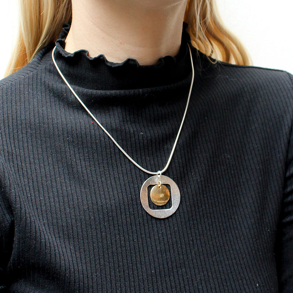 Marjorie Baer Necklace: Cutout Disc with Hanging Disc, Brass & Silver